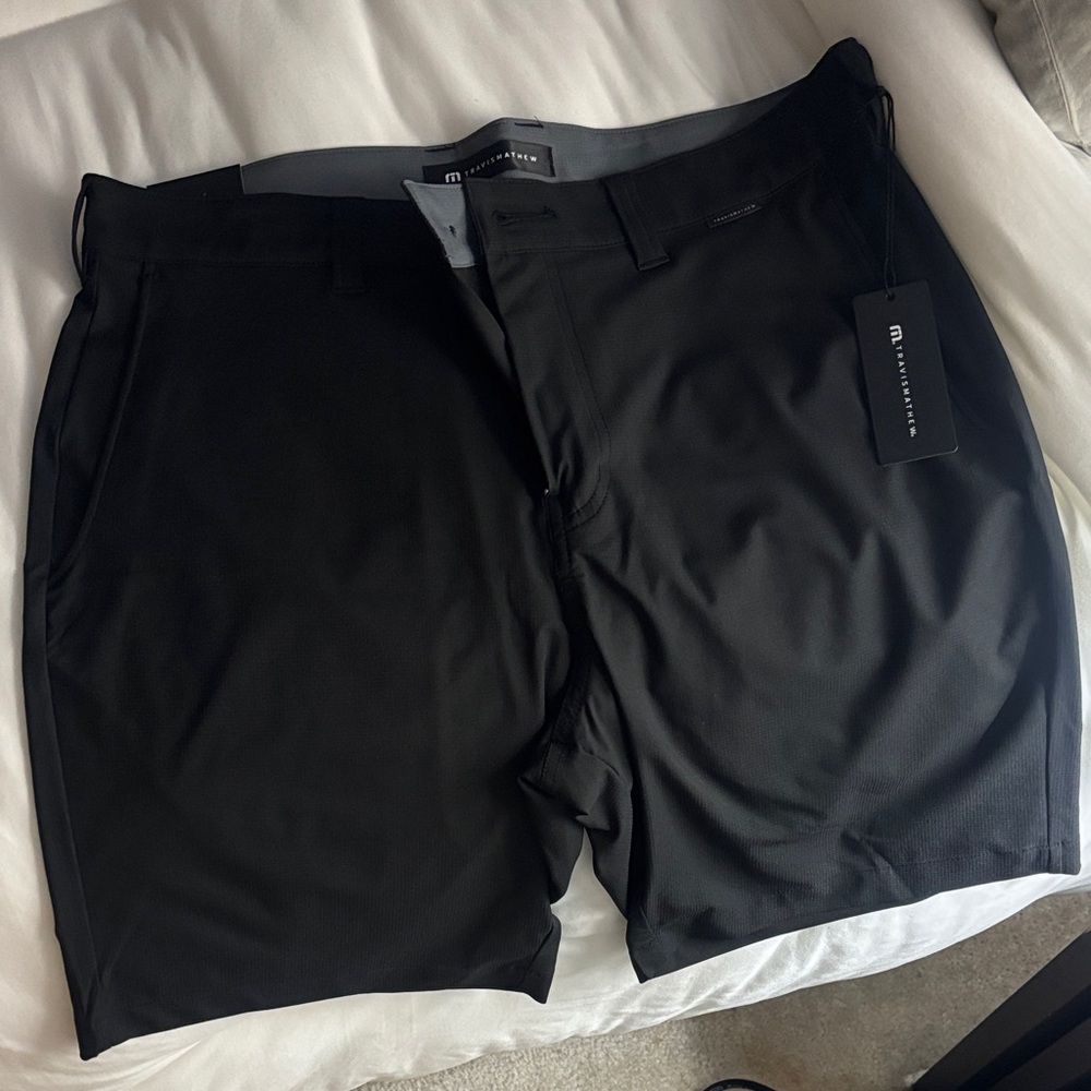 2 pair Travis Mathew Wanderlust Shorts 9” inseam. 33 waist. Black and Grey.